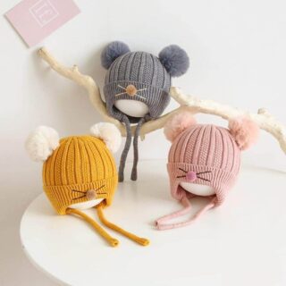 Bonnet en forme de chaton pour enfant sur une table.
