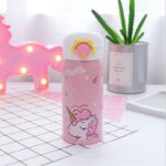 Gourde isotherme à motif licorne sur une table avec une plante