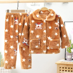 Pyjama polaire avec des étoiles et rayures pour enfants en marron et blanc avec motifs dans une chambre avec une plante derriere