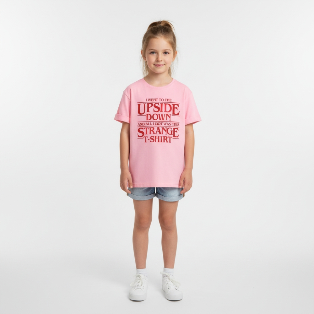 Petite fille portant un t-shirt rose Stranger Things, sur fond gris